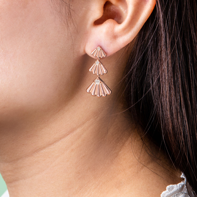 Photo of Anadara triple diamond earrings on ear