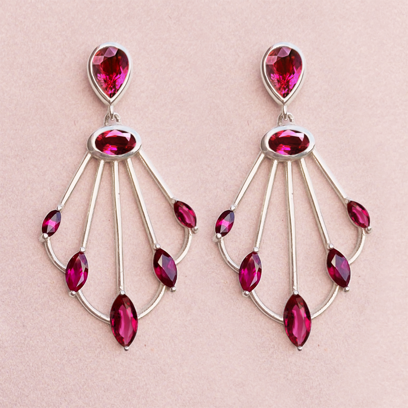 Photo of Sedna rhodolite scepter earrings on pink background